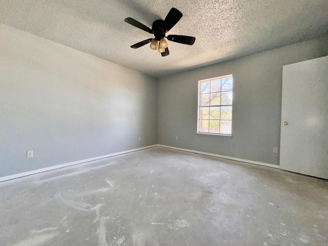 unfurnished room featuring ceiling fan, concrete floors, and a textured ceiling