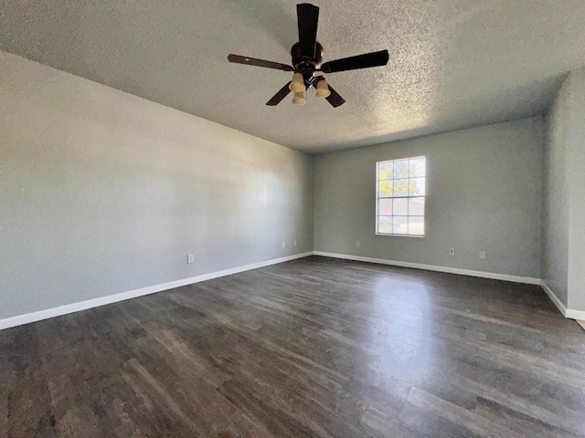 unfurnished room with ceiling fan, dark wood-type flooring, and a textured ceiling