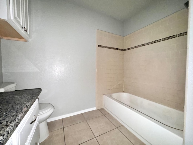 full bathroom featuring tile patterned flooring, vanity, tiled shower / bath combo, and toilet