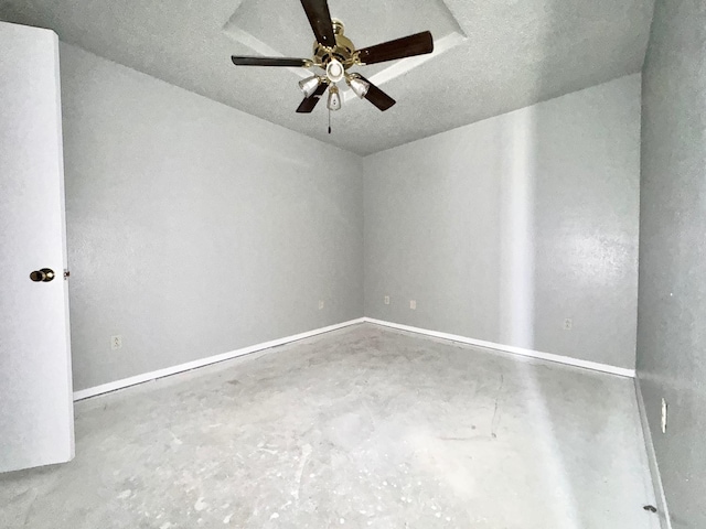 empty room with a textured ceiling, concrete flooring, and ceiling fan