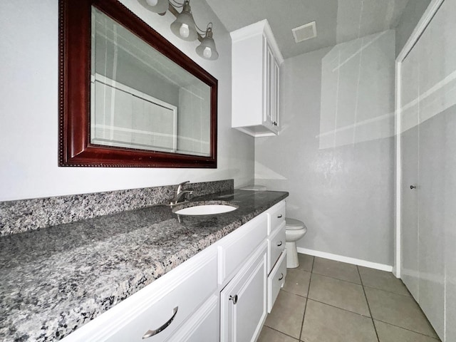 bathroom with vanity, tile patterned floors, and toilet