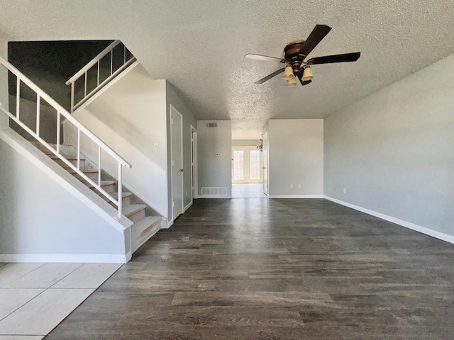 interior space with ceiling fan, dark wood-type flooring, and a textured ceiling