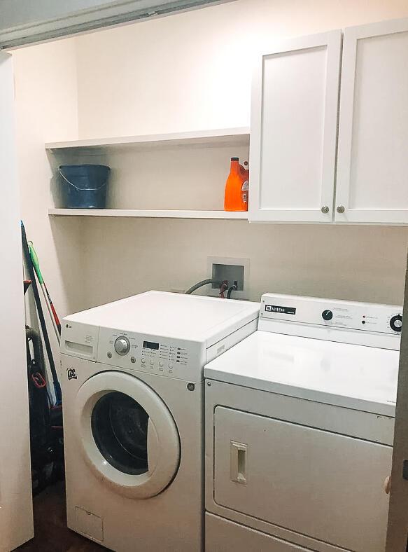 2003 30th St, Lubbock, TX 79411 - laundry room with washer and dryer and cabinet space