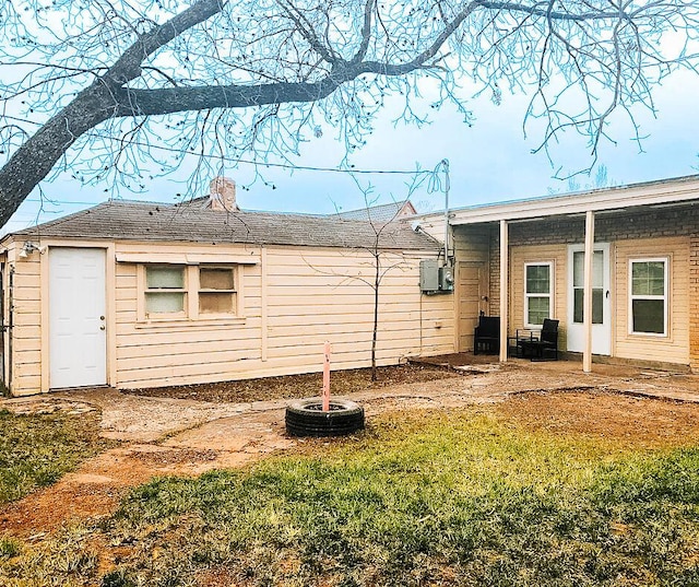 2003 30th St, Lubbock, TX 79411 - view of property exterior with a lawn and a chimney