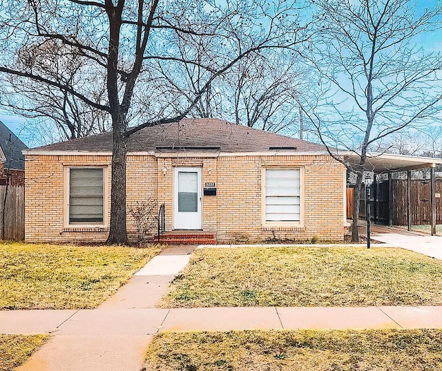 2003 30th St, Lubbock, TX 79411 - view of front of property with a carport, brick siding, and entry steps