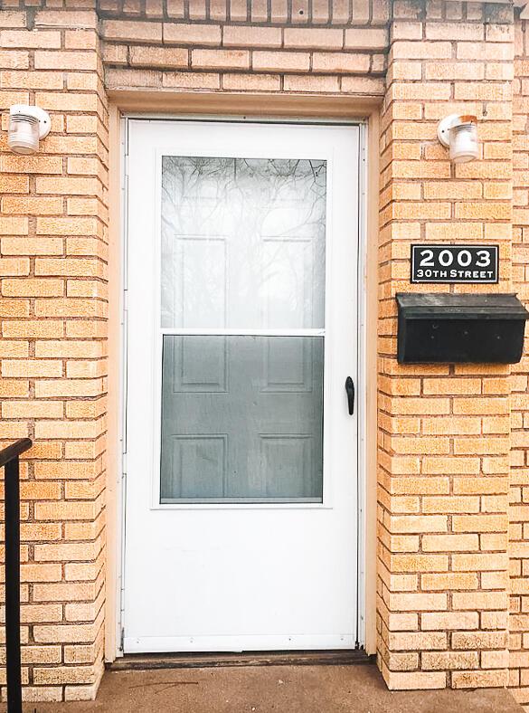 2003 30th St, Lubbock, TX 79411 - property entrance featuring brick siding