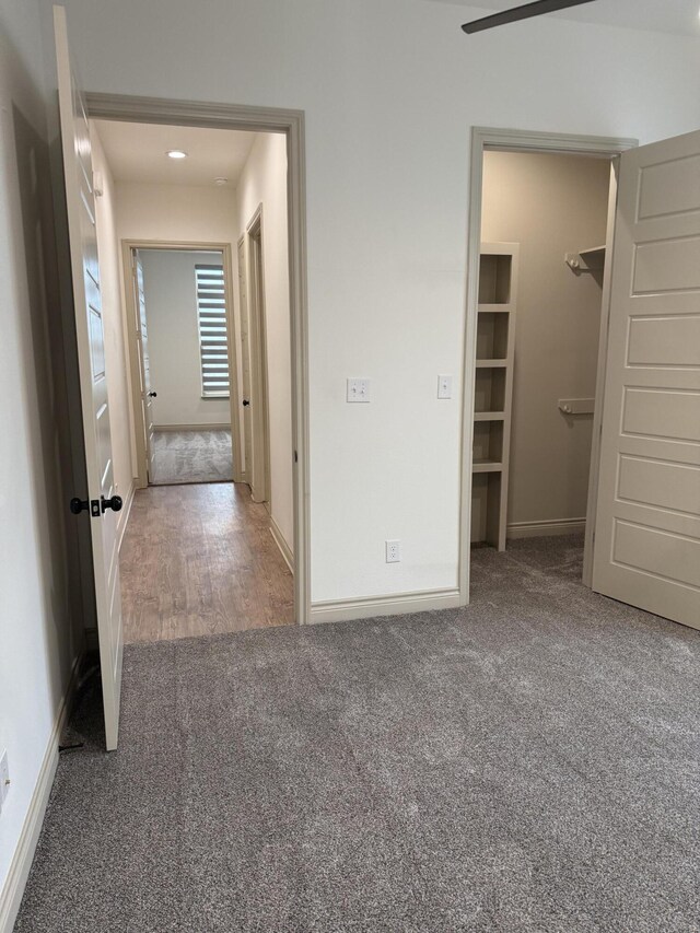 5414 112th St, Lubbock, TX 79424 - unfurnished bedroom with carpet flooring, a walk in closet, and baseboards