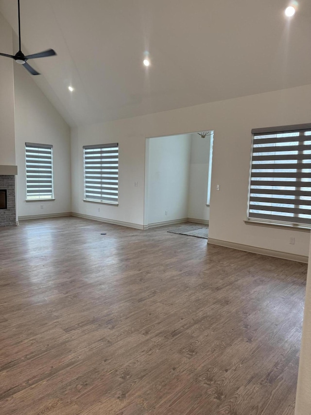5414 112th St, Lubbock, TX 79424 - unfurnished living room with ceiling fan, wood finished floors, a brick fireplace, baseboards, and recessed lighting