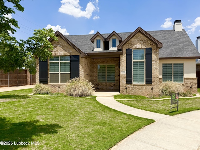 5414 112th St, Lubbock, TX 79424 - view of front facade featuring brick siding, a chimney, and roof with shingles