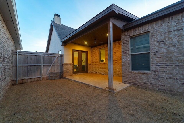 5414 112th St, Lubbock, TX 79424 - rear view of house with a patio area, a chimney, brick siding, and french doors