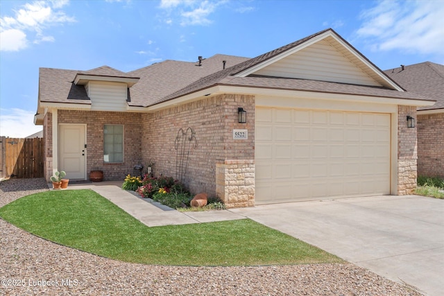 5522 Lehigh St, Lubbock, TX 79416 - view of front of house featuring driveway, a garage, a shingled roof, brick siding, and stone siding