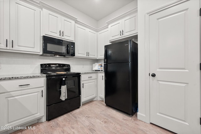 5522 Lehigh St, Lubbock, TX 79416 - kitchen with black appliances, white cabinets, light wood-type flooring, and light stone countertops
