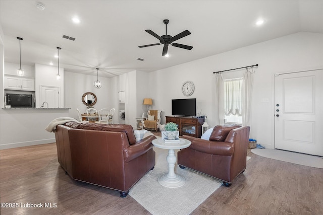 5522 Lehigh St, Lubbock, TX 79416 - living area with wood finished floors, a ceiling fan, washer / clothes dryer, recessed lighting, and lofted ceiling