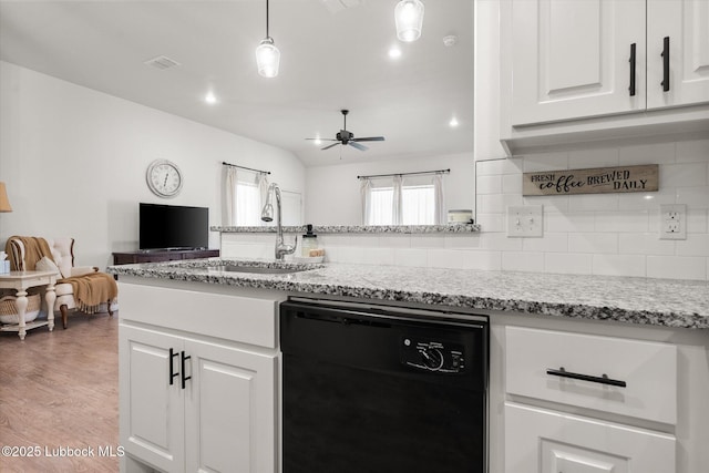5522 Lehigh St, Lubbock, TX 79416 - kitchen with dishwasher, open floor plan, decorative backsplash, ceiling fan, and white cabinetry