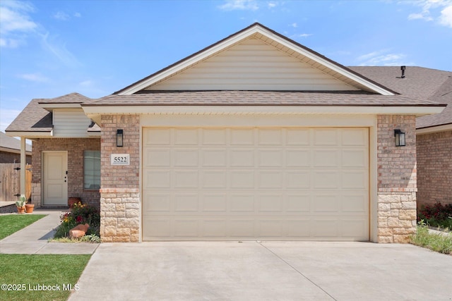 5522 Lehigh St, Lubbock, TX 79416 - view of front of house with concrete driveway, an attached garage, a shingled roof, and stone siding
