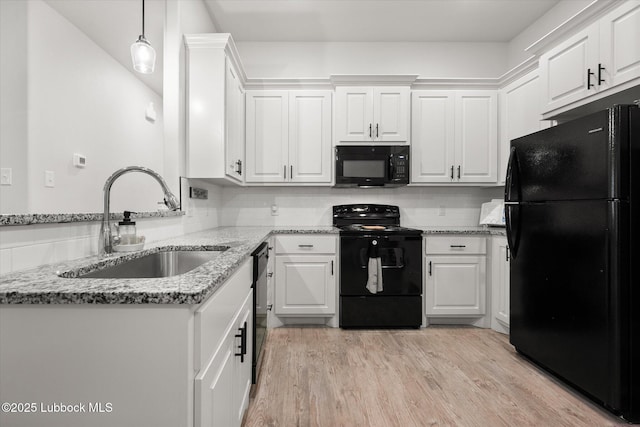 5522 Lehigh St, Lubbock, TX 79416 - kitchen featuring black appliances, white cabinets, light stone countertops, and light wood-type flooring