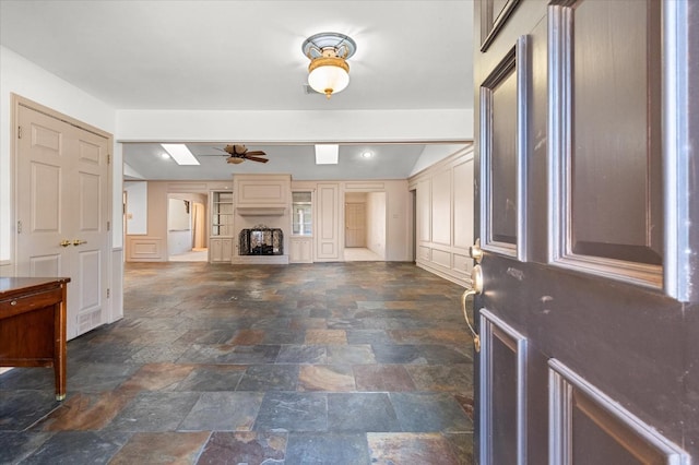 unfurnished living room with ceiling fan