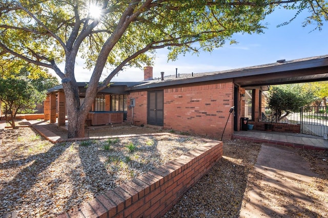 rear view of property with a hot tub