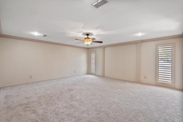 empty room with ornamental molding, carpet floors, and ceiling fan