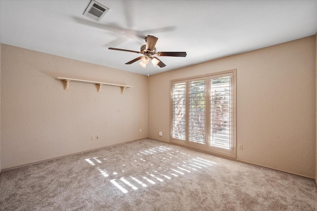 carpeted spare room with ceiling fan