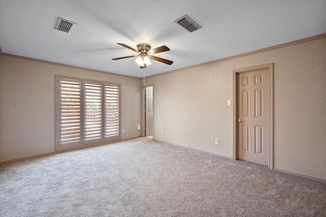 carpeted empty room featuring crown molding and ceiling fan