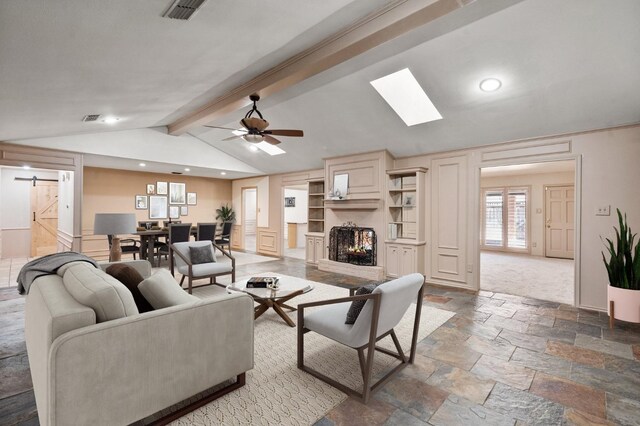 10 Brentwood Cir, Lubbock, TX 79407 - living room featuring a barn door, vaulted ceiling with skylight, and ceiling fan