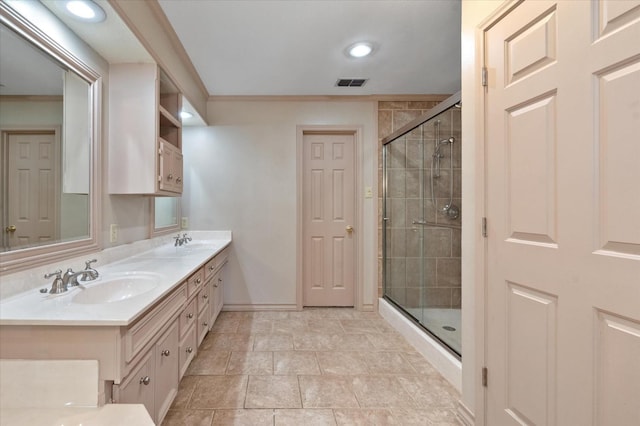 bathroom featuring vanity, ornamental molding, and an enclosed shower