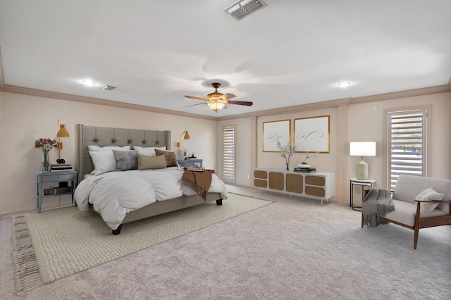 carpeted bedroom featuring crown molding and ceiling fan