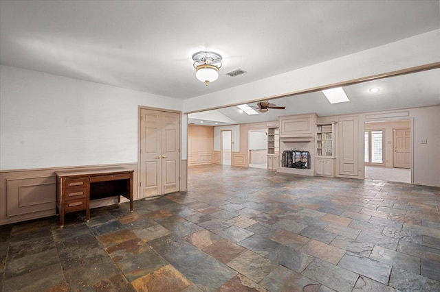 unfurnished living room with ceiling fan