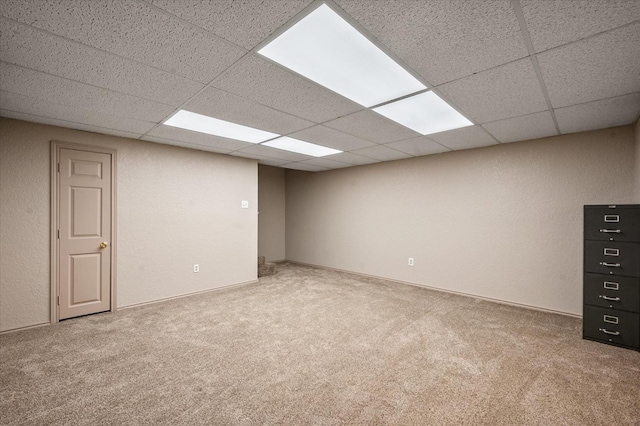 unfurnished room featuring a paneled ceiling and carpet