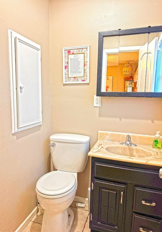 bathroom with vanity, toilet, and tile patterned flooring