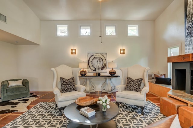 sitting room with tile patterned flooring and a high ceiling