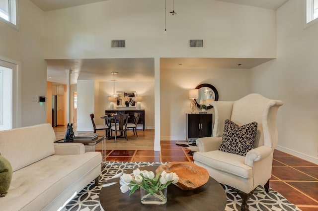 tiled living room with a high ceiling