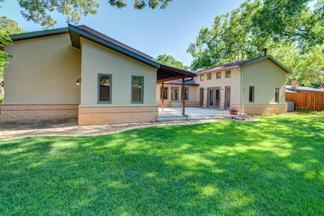 back of house featuring a yard and a patio area