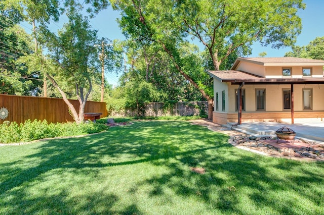 view of yard featuring a patio area and an outdoor fire pit