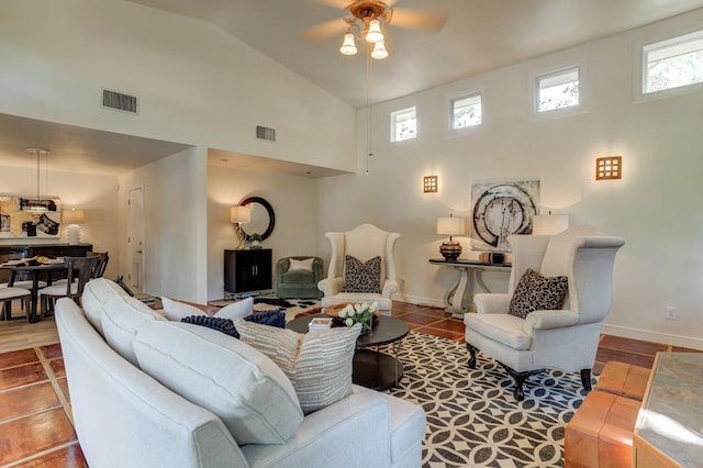 living room with high vaulted ceiling, plenty of natural light, tile patterned floors, and ceiling fan