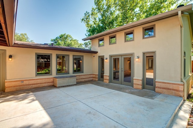 back of property with french doors and a patio