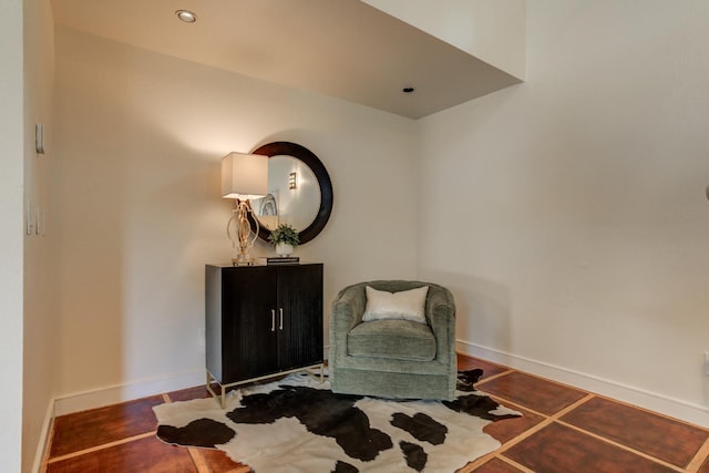 sitting room with dark tile patterned floors