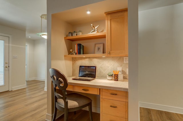 office area featuring built in desk and light wood-type flooring