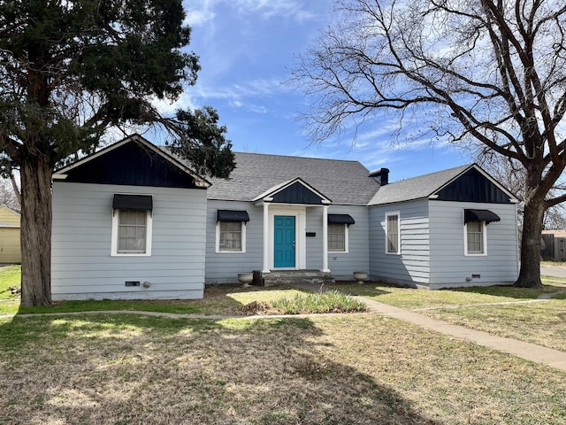 ranch-style house with a shingled roof, crawl space, a front yard, and board and batten siding