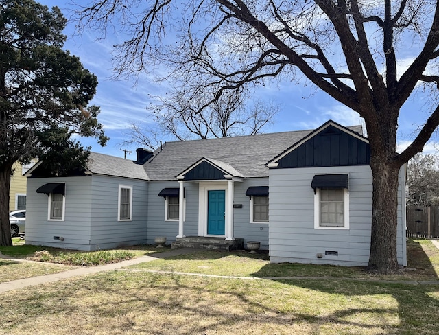 view of front of property with board and batten siding, a front yard, crawl space, and roof with shingles