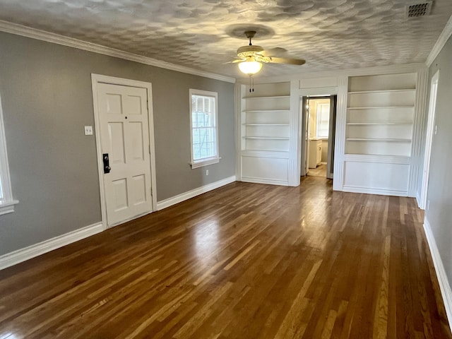 interior space featuring a textured ceiling, visible vents, baseboards, dark wood finished floors, and crown molding