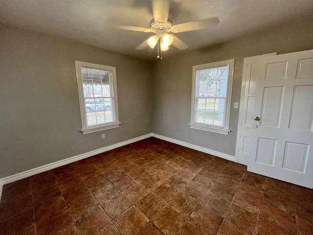 foyer featuring plenty of natural light, baseboards, and ceiling fan