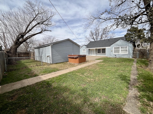 view of yard featuring a hot tub and a fenced backyard