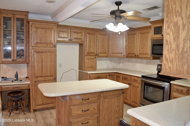 200 Crescent Dr, Littlefield, TX 79339 - kitchen with light countertops, appliances with stainless steel finishes, visible vents, and backsplash