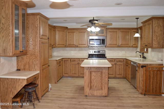 200 Crescent Dr, Littlefield, TX 79339 - kitchen with light wood-style flooring, tasteful backsplash, appliances with stainless steel finishes, and a sink