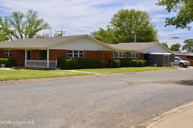 200 Crescent Dr, Littlefield, TX 79339 - ranch-style house with a chimney, a front yard, brick siding, and a garage