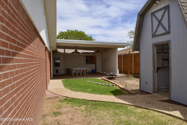 200 Crescent Dr, Littlefield, TX 79339 - view of yard with a patio area, an outdoor structure, fence, and a ceiling fan