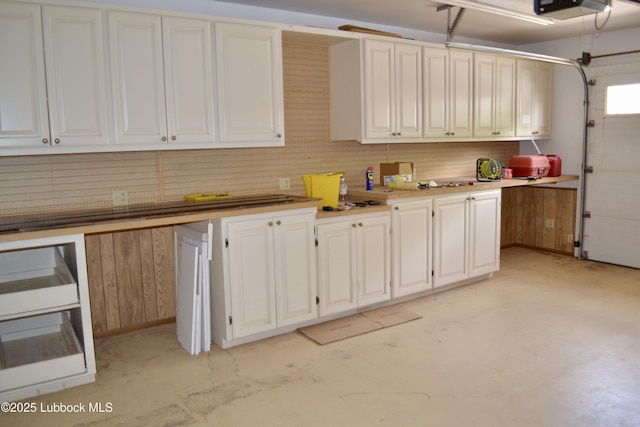 200 Crescent Dr, Littlefield, TX 79339 - kitchen with light countertops, white cabinets, and concrete floors