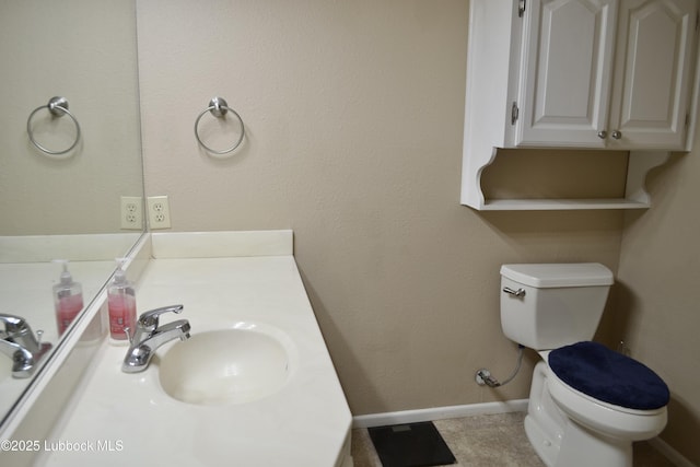 200 Crescent Dr, Littlefield, TX 79339 - half bath featuring toilet, baseboards, and vanity